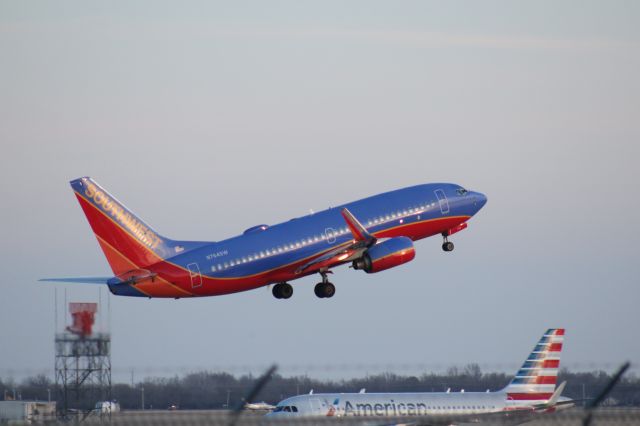 Boeing 737-700 (N764SW) - 022414 SWA outbound from Rwy 19R, AA A319 N9012 taxiing in