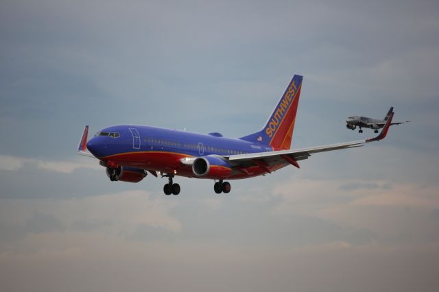 Boeing 737-700 (N255WN) - Landing on 16L while Spirit Airbus behind it lands on 16R at DIA.