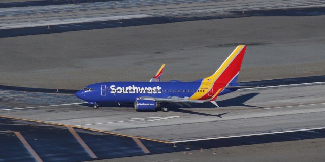 Boeing 737-700 (N7889A) - Leaving the active runway (16R-34L) at the 34L end after landing on 16R to complete a flight from San Jose (KSJC).