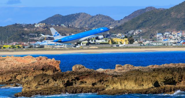 Airbus A330-200 (PH-AOB) - KLM registration PH-AOB aircraft type airbus A330-200 seen departing and climbing the hills at TNCM St Maarten bound to there next destination.