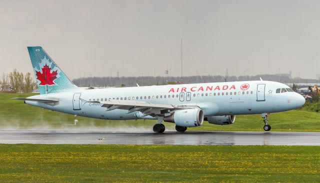 Airbus A320 (C-FNVU) - Touching down on a wet runway 33L at YYZ