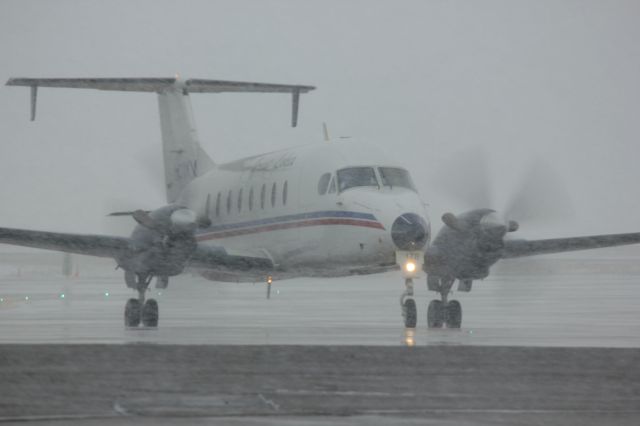 Beechcraft 1900 (N178YV) - Taxiing for take off after deice