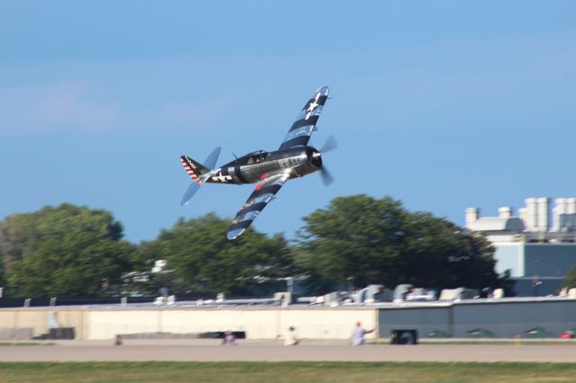 REPUBLIC Thunderbolt (NX4747D) - Low pass by the Thunderbolt over the Ground Pyro Team during the Saturday Afternoon Oshkosh AirVenture Show. 