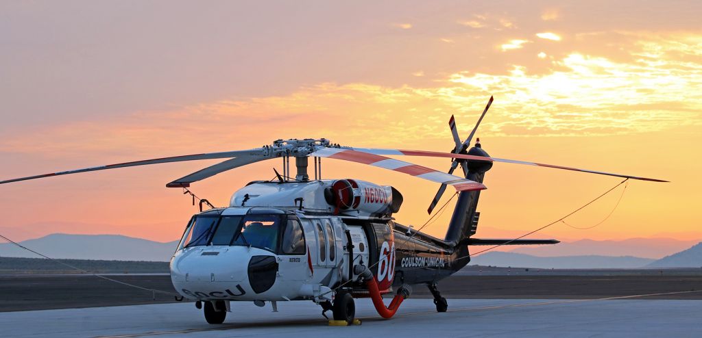 Sikorsky S-70 (N60CU) - Coulson-Unical's Sikorsky Helitanker (N60CU) is caught this morning on the RTS ramp awaiting the arrival of the crew. The beautiful early morning sunrise visible behind it is caused by heavy smoke from the Loyalton Fire which, ironically, is the same wildfire that, when its crew arrives, N60CU will be helping to extinguish.