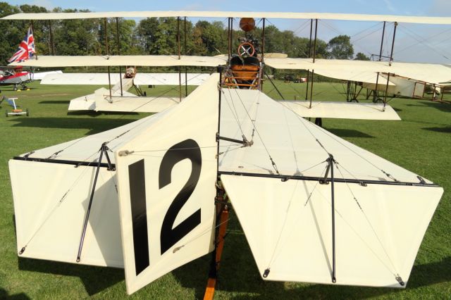 — — - The wide angle lens exagerates the apparent size of the vertical and horizontal stabilizer of this Avro Triplane.