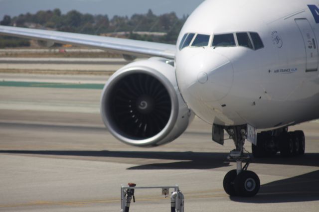 Boeing 777-200 (F-GSQV) - Following a pin point center line landing, Ground crews had to hook up the tug, after the crew missed their gate.