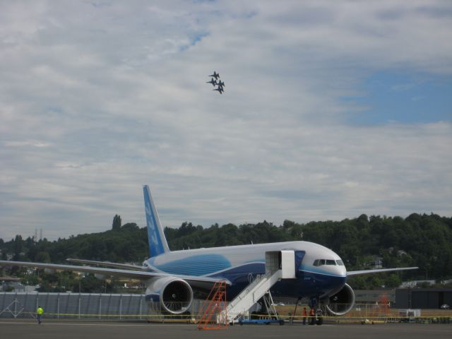 — — - A squad of Blue Angels flying over a Boeing 787-8 in 2008