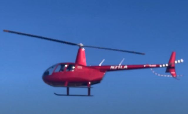 Robinson R-44 (N21LA) - This beautiful R44 Raven helicopter was landing at the south ramp at Greenville Downtown Airport (KGMU) when this picture was taken on Febuary 1, 2025. After this picture, the pilot of this helicopter did an outstandingly smooth landing. Photo Credit: AVNATION999 YouTube