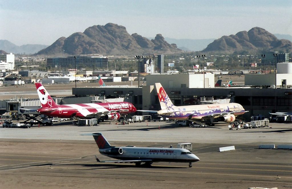 — — - KPHX - America West terminal at Phoenix - 2 757 Logo jets readied for the next flight!