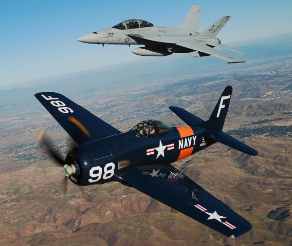 N8TF — - A Grumman F8F Bearcat from the Planes of Fame air museum (Chino, CA) is escorted by a US Navy Boeing F/A-18F Super Hornet.