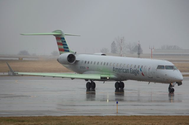 Canadair Regional Jet CRJ-700 (N715SK) - The green deicing fluid really stands out from the gray, sleeting late March day. American Eagle (SkyWest) 3208 is taxing to Runway 13 for departure to Chicago O'Hare at 4:33 PM. Photo taken March 22, 2020 with Nikon D3200 at 155mm.