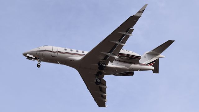 Canadair Challenger 350 (N769QS) - A Netjets Bombardier Challenger 350 landing at Philadelphia International Airport on December 4th, 2016.br /br /Photo taken from the ILS antennas at the beginning of runway 35. For an idea on how close this was, the focal length was 35mm.