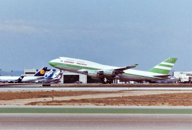 Boeing 747-400 (VR-HOO) - KLAX apprx Sept 90 I was in LAX are for the March Airline Collectible Show at The Hacienda Hotel, and the Friday before the show the Imperial terminal was usually busy with jet photographers - and this 747 being no exception shown rotating off Runway 25R for Hong Kong. VR-HOO was re-reg to B-HOO after July 1997. Cathay Pacific LN: 705 delv Sept 1989.