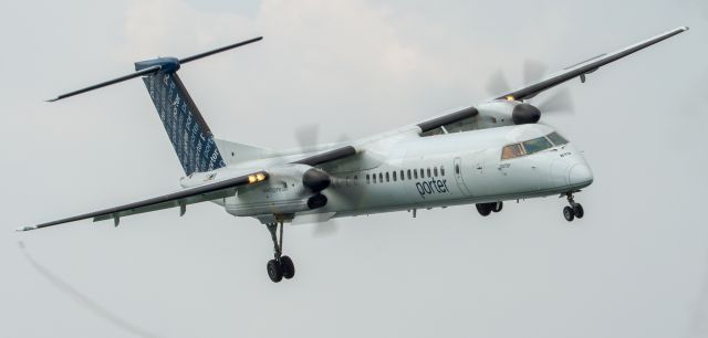 de Havilland Dash 8-400 (C-FLQY) - Porter Airlines Dash 8 lines up for runway 08 at the Island Airport in Toronto while Mike Wiskus puts his Pitts Special through its paces in the background