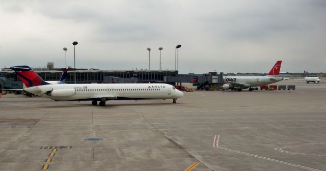 McDonnell Douglas DC-9-50 (N777NC) - 30+ years old now (in 2009) and freshly painted in DL colors, this DC-9-51 N777NC has a colorful history of previous paint jobs. Here she taxis at MSP next to NW A319 N301NB that will soon receive the DL branding too after the merger. Oct 16, 2009.