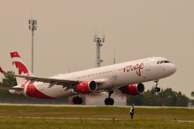 Airbus A321 (C-FJQL) - Air Canada Rouge A321 departing Regina on its way to Toronto with the heat waves making it a bit dificult for a decent photo