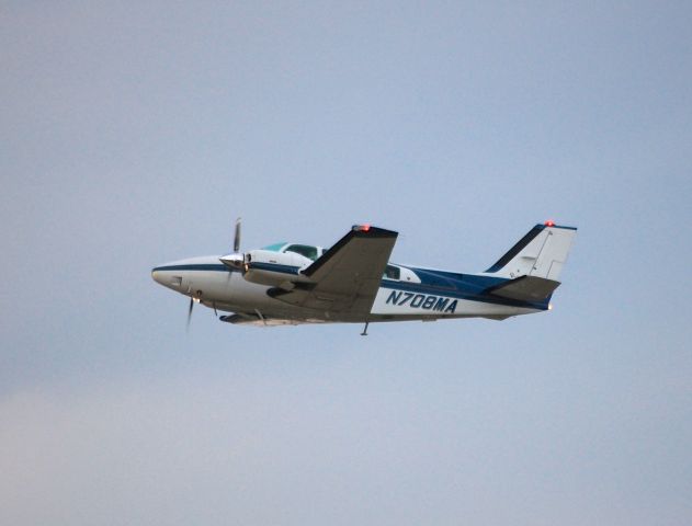 Beechcraft Baron (58) (N708MA) - Departing EAA Airventure/Oshkosh on 24 July 2012