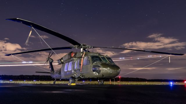 8323898 — - A UH-60L of the US Army sat a wet night at kpdx.