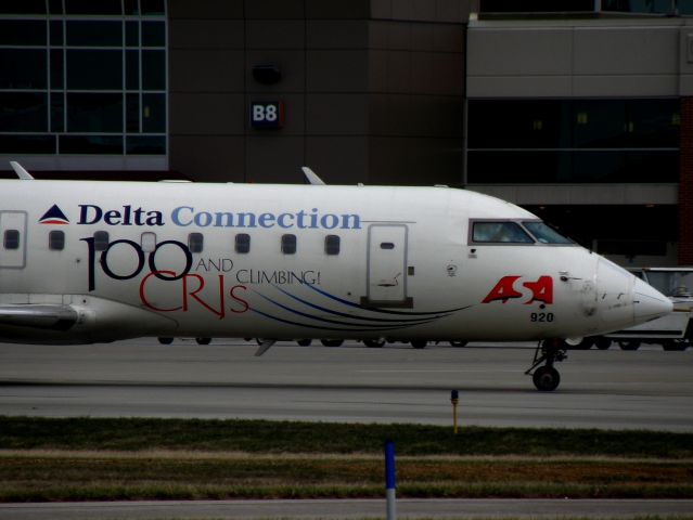 Canadair Regional Jet CRJ-200 (N920EV) - Detail of the 100 CRJs and climbing for ASA! livery ACEY 4964 (N920EV)... 4964 taxis to the gate at Blue Grass Airport (KLEX), in from Hartsfield-Jackson Intl (KATL)....