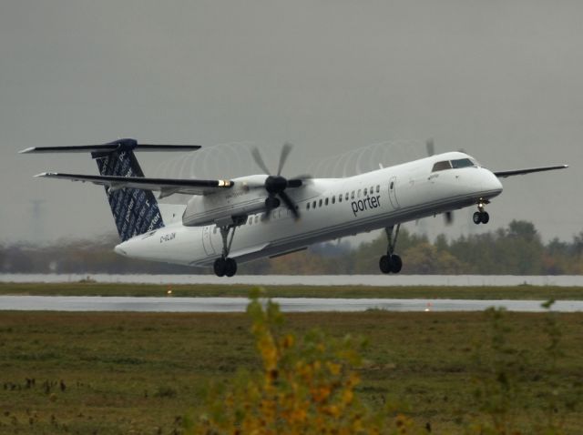 de Havilland Dash 8-400 (C-GLQN) - Taken Oct 13, 2009 on a cold and rainy day at YOW.  It was a good day for condensation trails off the wings and props.