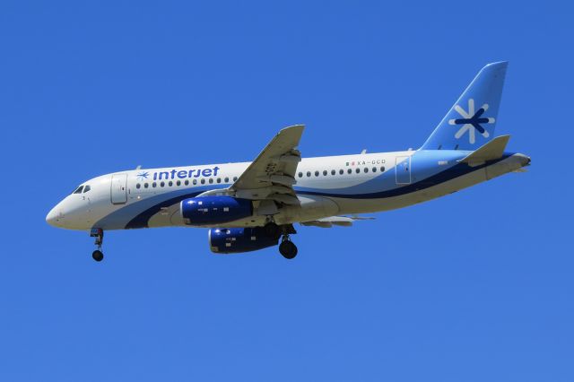 Sukhoi Superjet 100 (XA-GCD) - On final approach to SAT on a hot summer day.