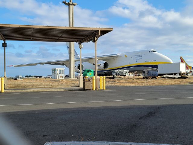 Antonov An-12 (UR-82007) - Flight ADB365F on the ramp near Terminal 3 at HNL 24APR21. Picture taken through a chain link fence, sorry for the chainlink in the bottom left corner.