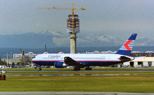 BOEING 767-300 (C-FCAJ) - CYVR - early 1990s photo from the old south terminal as a Canadien 767-300 departs with the new YVR Tower under construction in the background. 