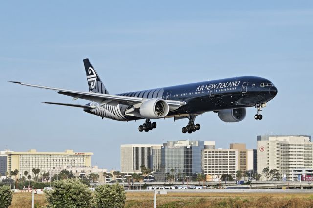 Boeing 777-200 (ZK-OKQ) - An Air New Zealand operated Boeing 777-300 series widebody jet in special "All Blacks" livery on final approach to the Los Angeles International Airport, LAX, in Westchester, Los Angeles, California. In the background, airport hotels along Century Boulevard