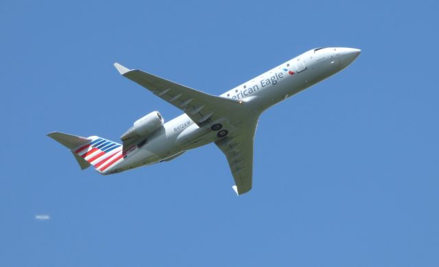 Canadair Regional Jet CRJ-200 (N412AW) - Shown here is a Canadair Regional Jet climbing out in the Summer of 2016. br /As too the other image behind the tail.................