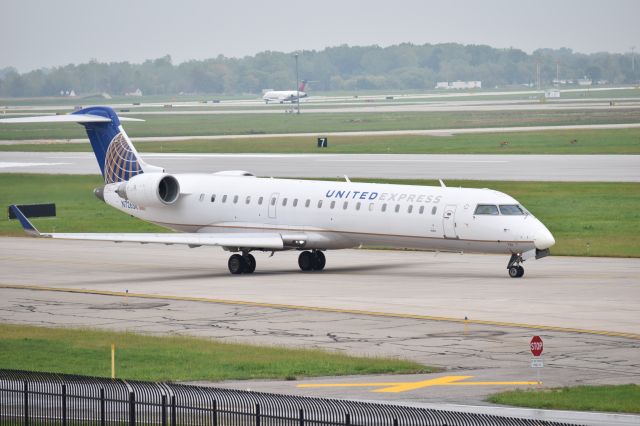 Canadair Regional Jet CRJ-700 (N726SK) - A SkyWest (opf United Express) CRJ700 taxis up to Runway 3L for departure at Detroit. This aircraft is now operated for American Eagle. Photo taken 10/3/2016.