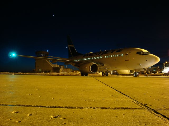 — — - Sliver of a moon at dusk at the Fort McMurray, Alberta Airport