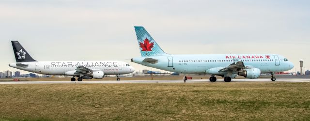 Airbus A320 (C-FDRH) - Air Canada A320 C-FDRH + C-FFWJ ; two different livery Air Canada A320 hold short for incoming traffic waiting for departure at Rwy 06 - Toronto YYZ.