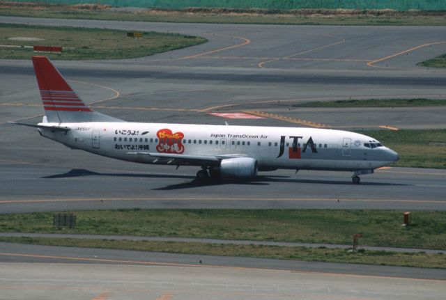 BOEING 737-400 (JA8597) - Taxing at Tokyo-Haneda Intl Airport on 2002/04/06 " Ikouyo! Oideyo! Okinawa Logo "