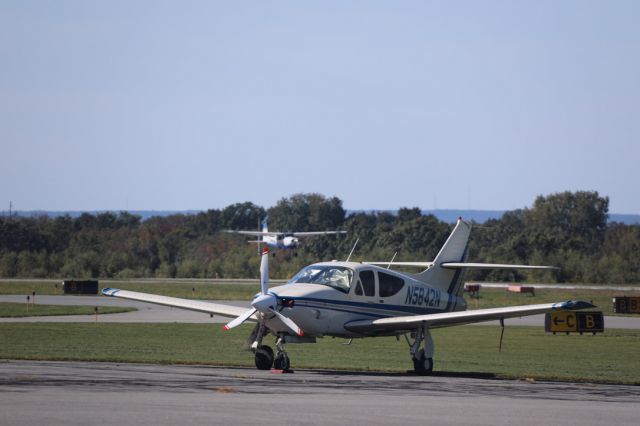 Rockwell Commander 114 (N5842N) - Standing on ramp, in front of main hanger.