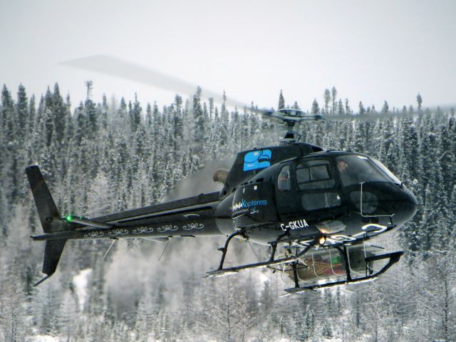 Eurocopter AS-350 AStar (C-GKUA) - C-GKUA, an Innukopteres Astar 350, taking of with workers surveying the future power line linking the Romaine-4 Dam and the Poste-Montagnais power station. Poste-Montagnais, Quebec - December 2013