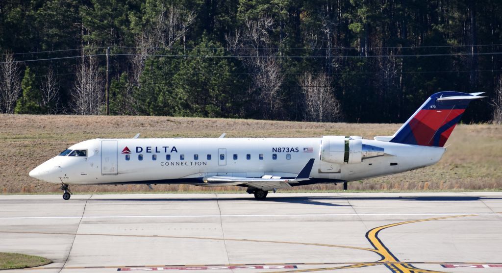 Canadair Regional Jet CRJ-200 (N873AS) - Little CRJ surviving Windmageddon after being slammed down pretty hard on 23R - from the RDU observation deck, 3/2/18.