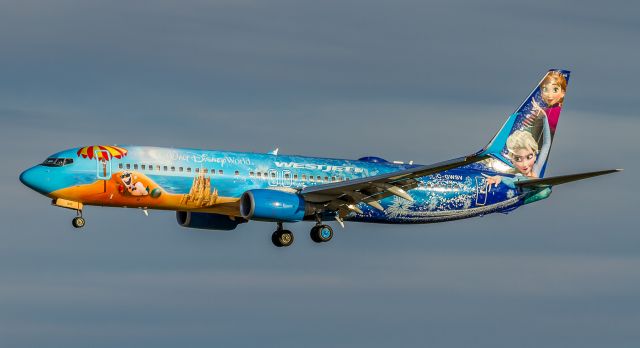 Boeing 737-800 (C-GWSV) - My last shots of the day nets me this Westjet Disney jet, about to land on runway 06…Frozen livery