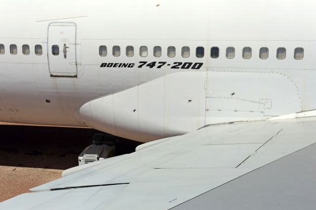 Boeing 747-200 (VH-EBQ) - View of the panels below and to the right of the Boeing 747-200 name, where the over wing door exit escape slide would deploy.