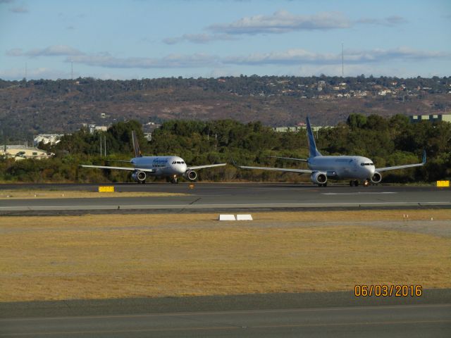 — — - Garuda Indonesia B738 to Jakarta. TigerAir A320 in the background