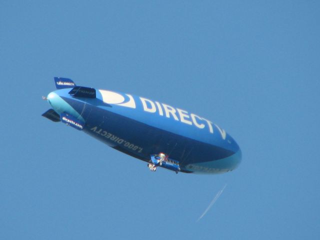 — — - DirectTV blimp crossing over.