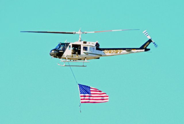 Bell UH-1V Iroquois (N911NV) - Flying past Carson City airport down Carson Street during parade