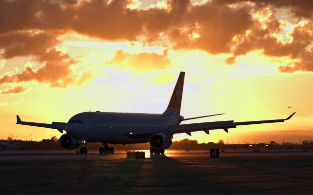 Airbus A330-200 (HB-IQJ) - just landed on R-8L with the setting sun