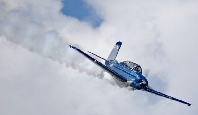 Beechcraft Mentor (N134JC) - Julie Clark in her beautifully restored T34 Mentor performing at Oshkosh AirVenture 2015!