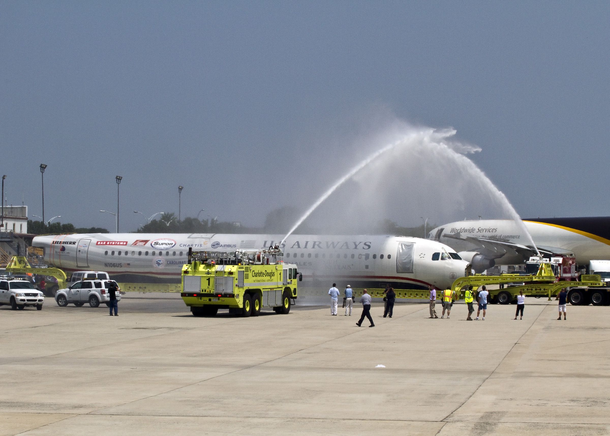 Airbus A320 (N106US) - Water Salute: The wreck of N106US, Flight 1549-"Miracle on the Hudson" arrives a little after 12:00 on Friday, 10 June 2011 at the Charlotte Airport. This plane went into the Hudson River next to Manhattan in New York City after ingesting geese in the engines. It "ditched" (made a water landing) on January 15, 2009. After more than 2 1/2 years, it finally arrived at Charlotte, its original destination, except by truck. Captain "Sully" Sullenberger and his First Officer Jeffrey B. Skiles were at the controls and were later awarded the "Masters Medal" from the "Guild of Air Pilots and Navigators" for the "Most Successful Ditching in History." Greeted in Charlotte with a water cannon salute, the plane made its way across runway 18L to its new home where it will be displayed permanently at the Carolinas Aviation Museum, Charlotte Airport (KCLT), North Carolina USA.