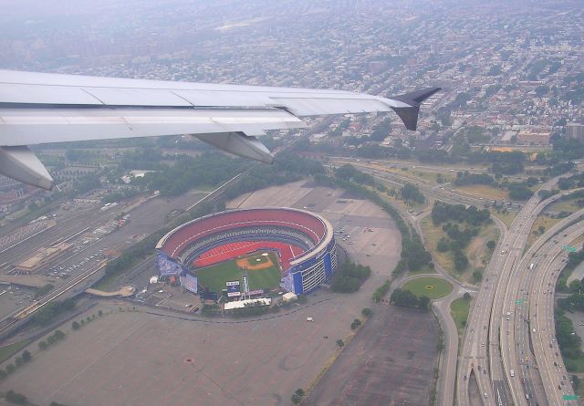 Airbus A319 (N770UW) - Shea Stadium, former home of the New York Mets as seen from USAirways A-319 N770UW flying the Whitestone Climb just after departing Runway 13 at KLGA back in June 2004. The Whitestone Expressway runs top to bottom on the right part of the photo and the Grand Central Parkway runs left to right mid photo and above the wing is the Corona section of Queens, New York.