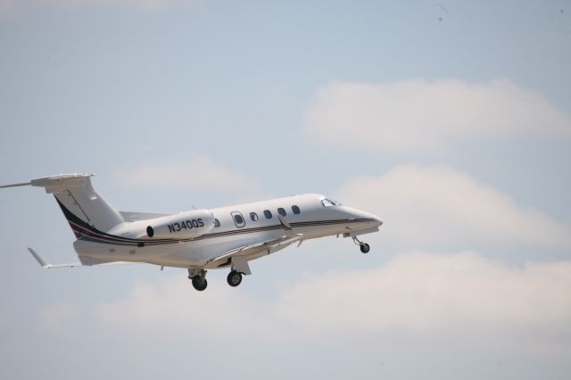 Embraer Phenom 300 (N340QS) - Gear going up, great cloud backdrop