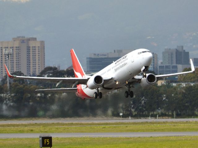 Boeing 737-800 (VH-VXD) - Getting airborne off runway 23 on a gloomy, cold winters day. Wednesday 4th July 2012.